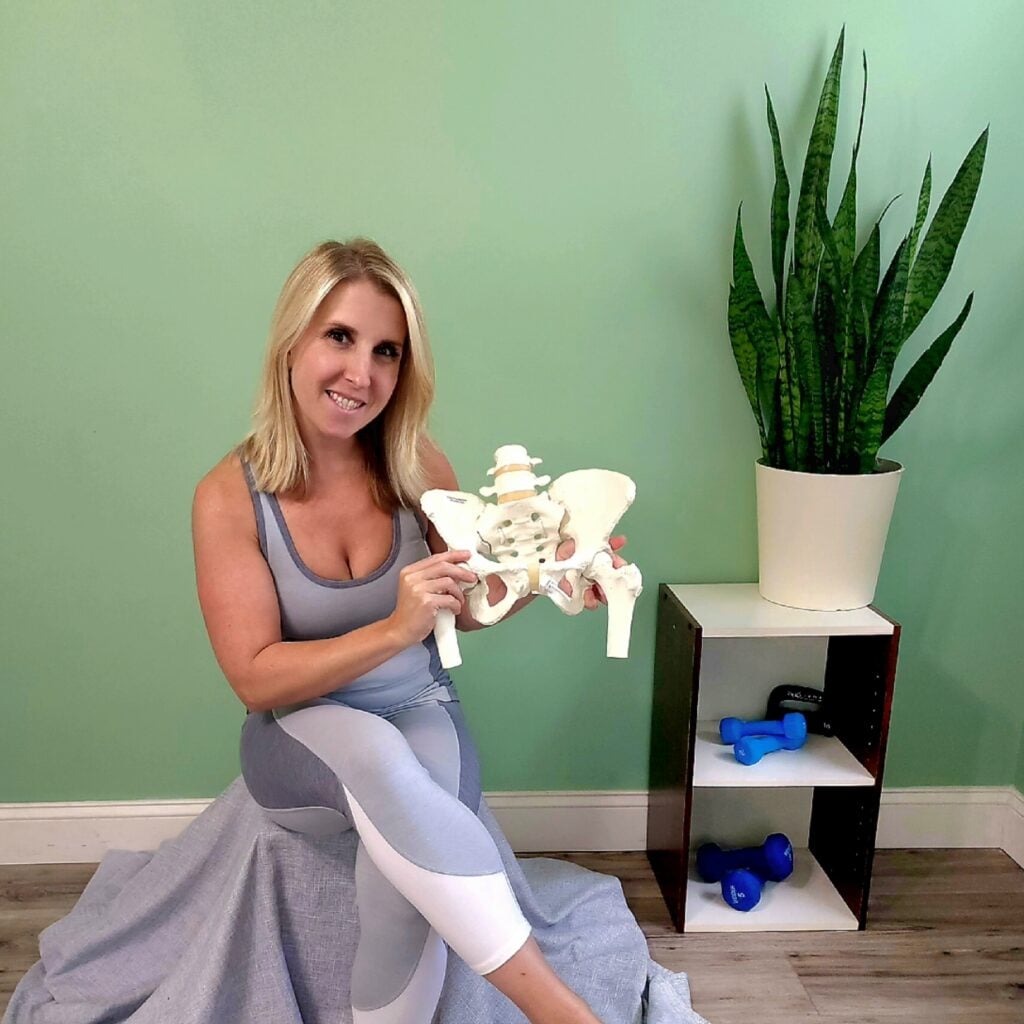 Rachael Van Schoick holding part of a human skeleton model, emphasizing pain points and solutions